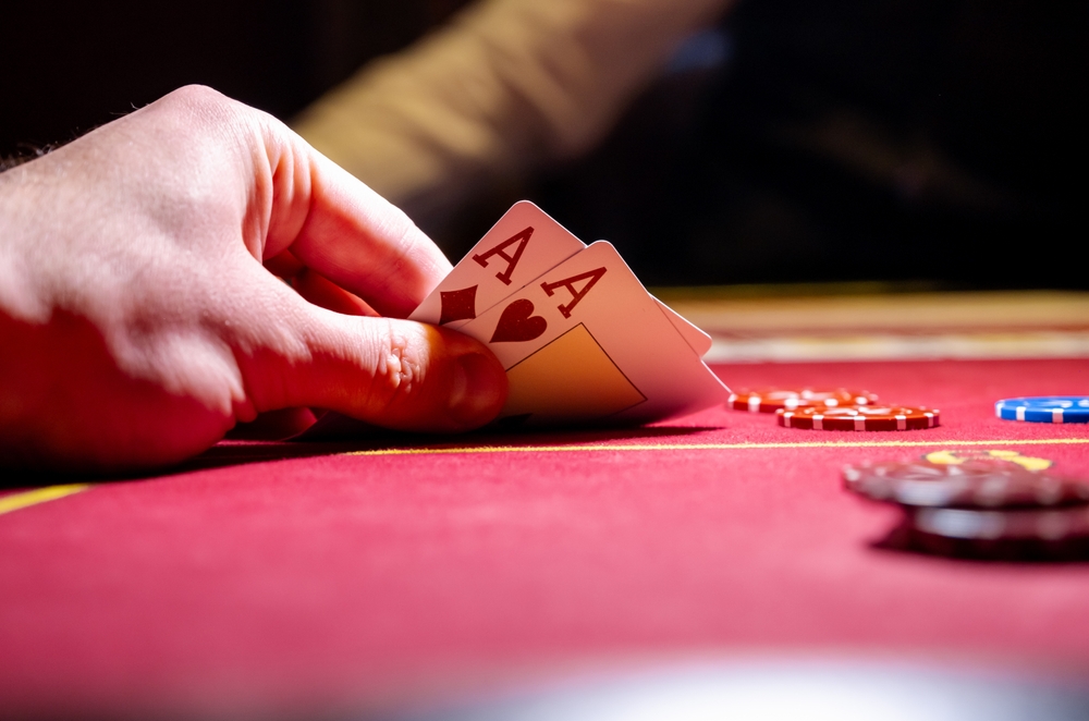 Two,Aces,And,Big,Stake,On,Red,Felt.,Gaming,Cards